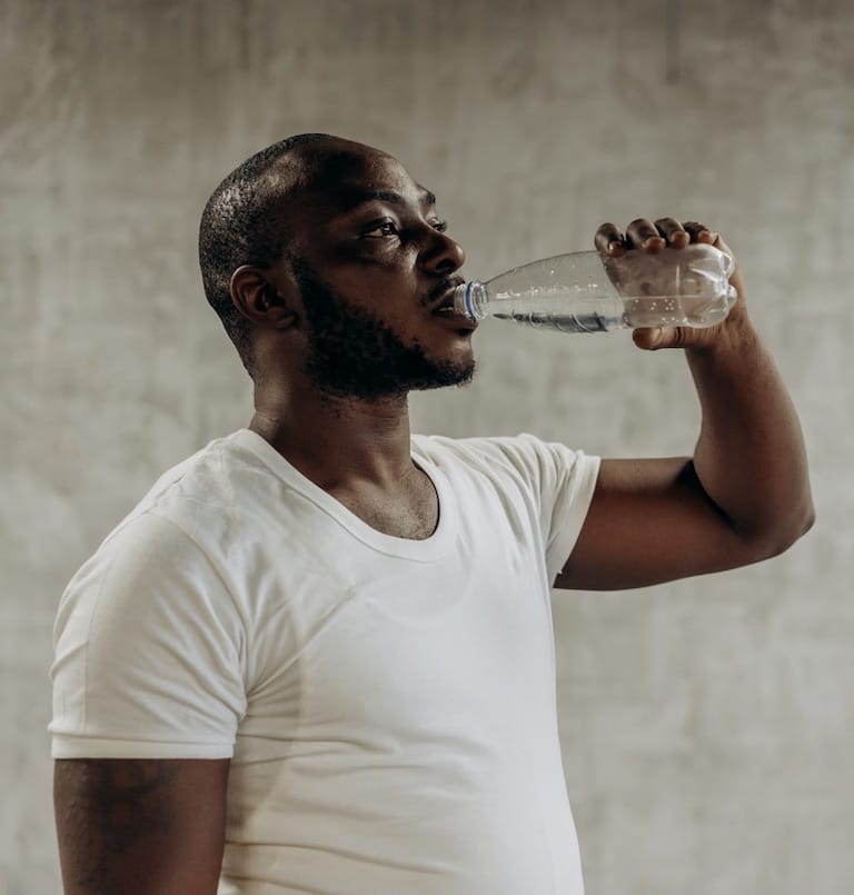 man drinking from waterbottle